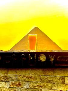 a glass of juice in front of the pyramid at King Cheops Inn - Pyramid View in Cairo