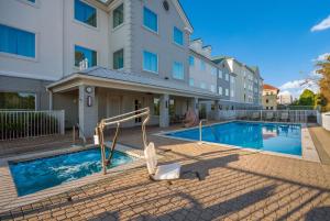 a swimming pool in front of a building at Best Western Sugar Sands Inn & Suites in Destin