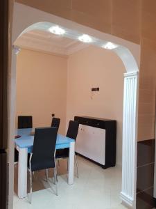 a dining room with a blue table and chairs at Appartement lala yasmine in Fez