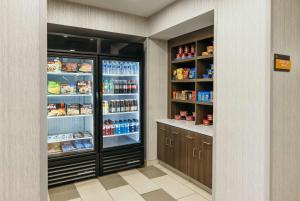 a kitchen with an open refrigerator with food and drinks at La Quinta Inn & Suites by Wyndham Ankeny IA - Des Moines IA in Ankeny
