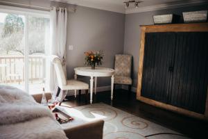 a living room with a table and a window at Taylor Creek Lodge in Gold Beach