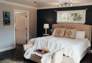 a bedroom with a large bed with a white comforter at Taylor Creek Lodge in Gold Beach