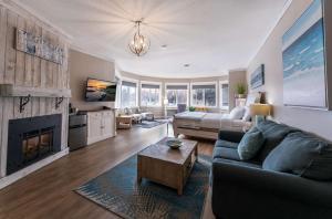 a living room with a couch and a fireplace at Prestige Beach House, WorldHotels Crafted in Kelowna