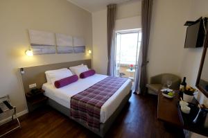 a hotel room with a large bed and a window at St Andrews Guest House in Jerusalem