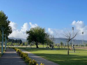a park with a sidewalk and trees and grass at Cantinhos Da Serra e Sopé, Soure in Soure