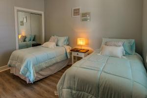 a bedroom with two beds and a lamp in it at Idyllic Myrtle Beach Condo Golf Course On-Site in Myrtle Beach