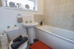 a bathroom with a sink and a tub and a toilet at 2 Bedroom Apartment-Free Parking-Private Entrance in Gateshead