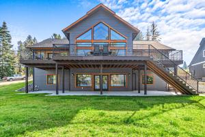 a large house with a deck and a balcony at Willow Bay in Priest River