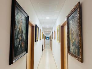 a hallway with paintings on the walls at Art House in Alicante