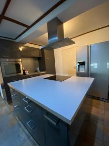 a kitchen with a white counter top in a kitchen at Cathédrale Saint-Nicolas Bnb in Fribourg