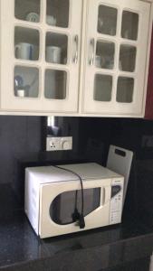a microwave sitting on a counter in a kitchen at Tranquil Private Villa near Bentota Beach in Bentota