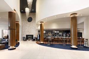 a lobby of a hotel with columns and a bar at Courtyard by Marriott Atlantic City Beach Block in Atlantic City