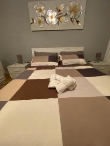 a bedroom with two beds with towels on it at HOME ADRIANA in Bari