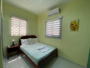 Dormitorio pequeño con cama y mesa en Apartamentos Melya cerca de la Playa Caleta en La Romana