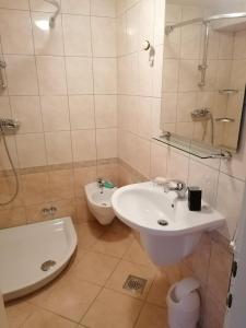 a bathroom with a sink and a toilet and a tub at Apartments with parking space Dajla, Novigrad - 6935 in Novigrad Istria