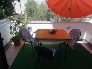 a table with chairs and an umbrella on a patio at Apartments with parking space Dajla, Novigrad - 6935 in Novigrad Istria +18 photos