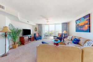 a living room with a couch and a tv at Yacht Club Villas 3-505 in Myrtle Beach