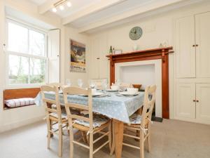 a dining room with a table and chairs at Banneth in Mawgan in Meneage