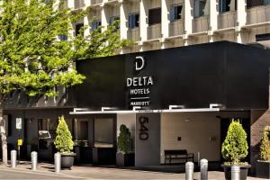 a building with a sign for a delta hotel at Delta Hotels by Marriott Kamloops in Kamloops