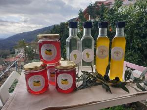 a table with four bottles of vinegar and jam at Rosemary House in Sarandë