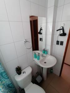 a bathroom with a toilet and a sink at Agradable casa en Padre Hurtado VI in Talagante