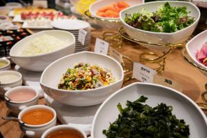 a table topped with bowls of food and other foods at Hotel Kanazawa in Kanazawa