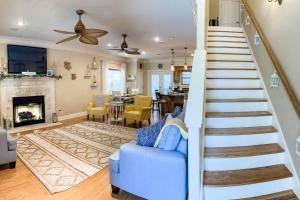 eine Treppe in einem Wohnzimmer mit einem blauen Sofa in der Unterkunft Pet Friendly Cottage Nestled in the Pines with Cozy Fire Pit only Minutes to BEACHES in Dauphin Island