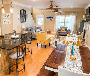 a kitchen and living room with a table and chairs at Pet Friendly Tranquil Cottage with Fire-Pit and Seasonal Hot Tub Sept-March Minutes to BEACHES in Dauphin Island +60 photos