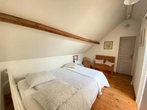 a bedroom with a white bed with two pillows at Cottage, Gulleville in Ganzeville