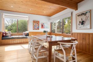 a dining room with a wooden table and chairs at Tetleys in Dinner Plain