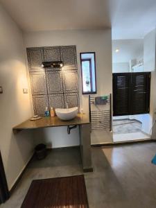 a bathroom with a sink and a large wooden door at beaux duplex in Deli Ibrahim