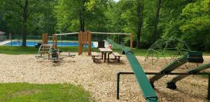 a park with a playground with a swing set at Shenandoah 1 Summer Camp in the Laurel Highlands in Champion