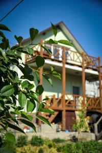 a house with a deck on the side of it at Green Town Apartment in Chortkiv