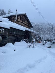 a snow covered house with a pile of snow at Wan de En - Vacation STAY 83694v in Sabae