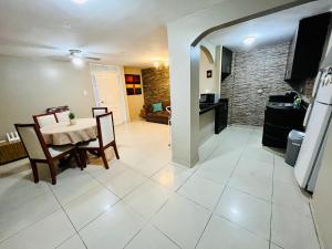 a kitchen and a dining room with a table and chairs at Suite in the exclusive area of San Marino in Guayaquil