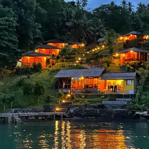 a resort on the shore of a river at night at K2 Lembeh Dive Resort in Bitung