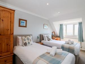 a bedroom with two beds and a window at Lookout in Weymouth