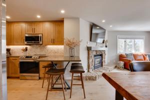 a kitchen with a counter and a living room at Breckenridge Condo with Balcony and Resort Amenities in Breckenridge
