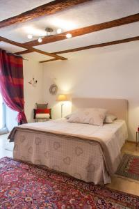 a bedroom with a large bed in a room at La Maison des Tanneurs in Ribeauvillé