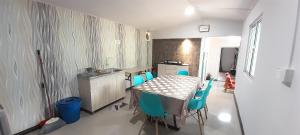 a kitchen with a table and chairs in a room at Wind Valley Farmstay in Kampong Kundassan