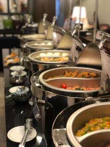 a buffet line with many plates of food at Airo Hotel Manila in Manila
