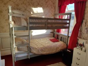 a bedroom with two bunk beds and a window at The Brema Hotel in Blackpool