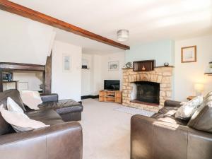 a living room with couches and a fireplace at Manor View in Oakham