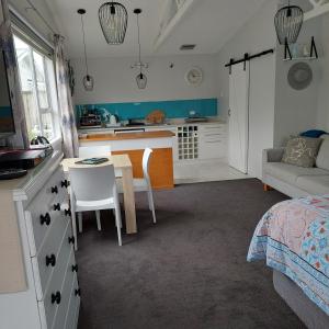 a kitchen and living room with a bed and a table at Welbourn Accommodation in New Plymouth