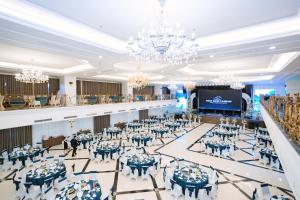 a banquet hall with tables and chairs and a stage at Ninh Binh Legend Hotel in Ninh Binh +154 photos