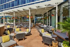 a patio with chairs and tables in a building at Walt Disney World Swan Reserve in Orlando