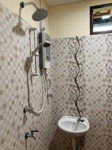 a bathroom with a shower and a sink at Teratak Bayu STC in Kuala Terengganu