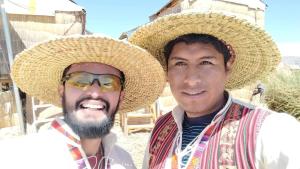 zwei Männer mit Hüten, die nebeneinander stehen in der Unterkunft Titicaca Kontiki Lodge Peru in Puno