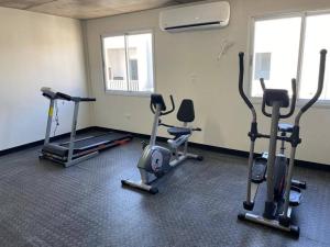a gym with several exercise bikes in a room at Acogedor dpto! Zona Conmebol 505 in La Mercedes