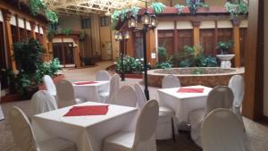 a banquet hall with white tables and chairs and a fountain at Canad Inns Destination Centre Fort Garry in Winnipeg
